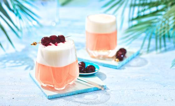 Cherry-Sour Two cherry sours in glasses garnished with 3 cherries.